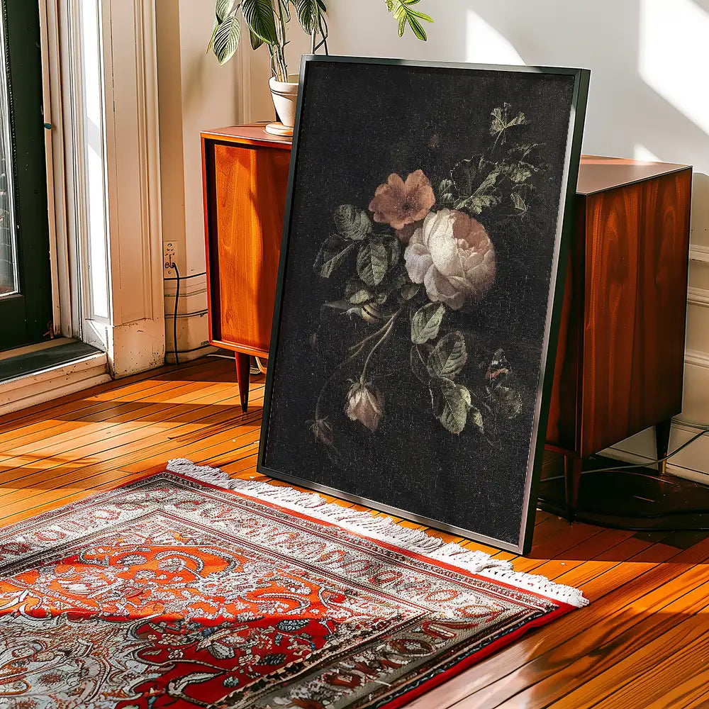 Framed painting of flowers displayed in a stylish room with wooden flooring and an ornate rug.