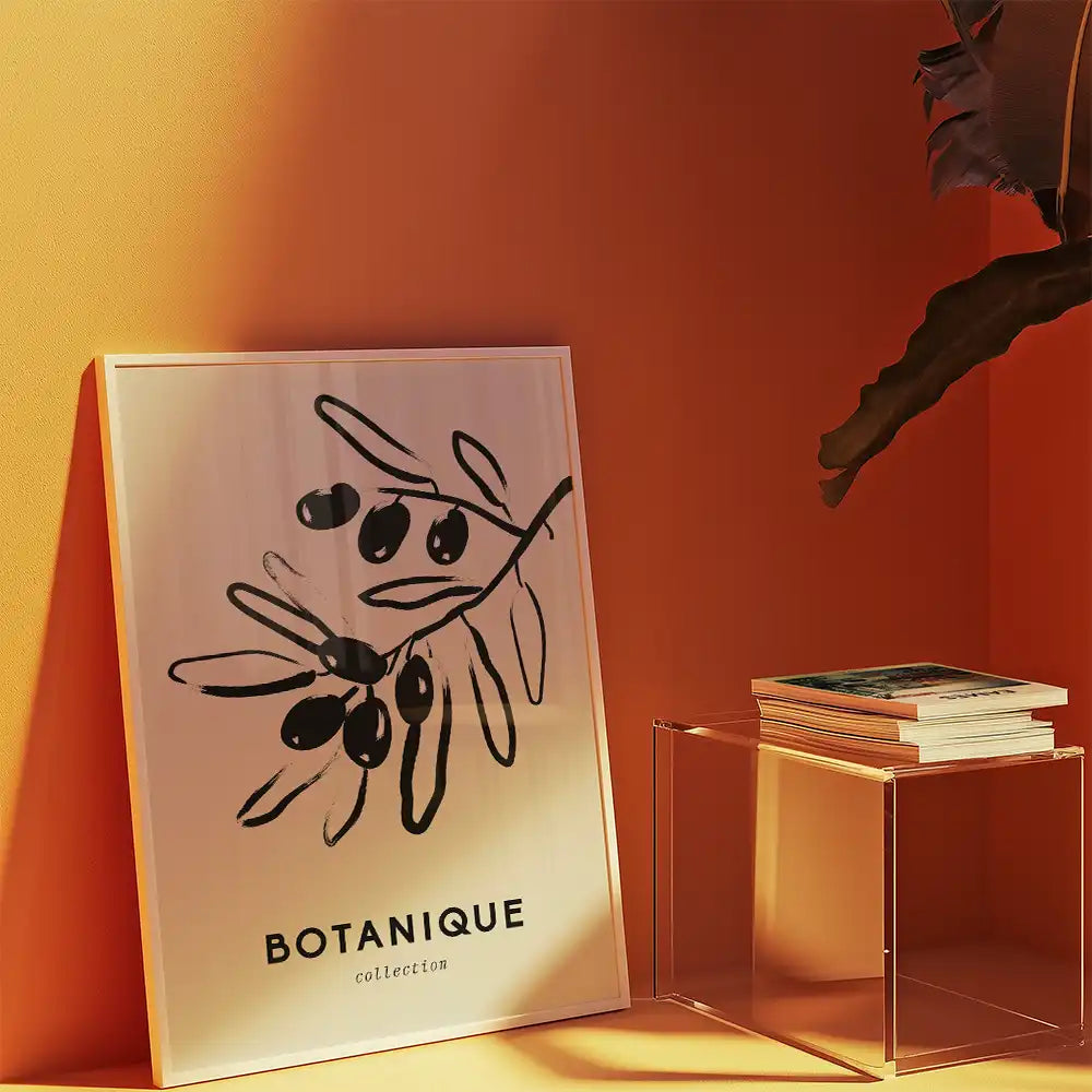 Modern botanical art print featuring a minimalist olive branch design titled "BOTANIQUE" displayed against a warm orange wall, perfect for contemporary home decor.