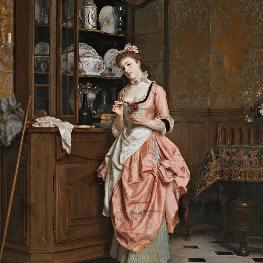 A young woman dressed in a pink gown stands thoughtfully beside a wooden cabinet adorned with fine china and glassware, set in a warmly lit, vintage kitchen interior.