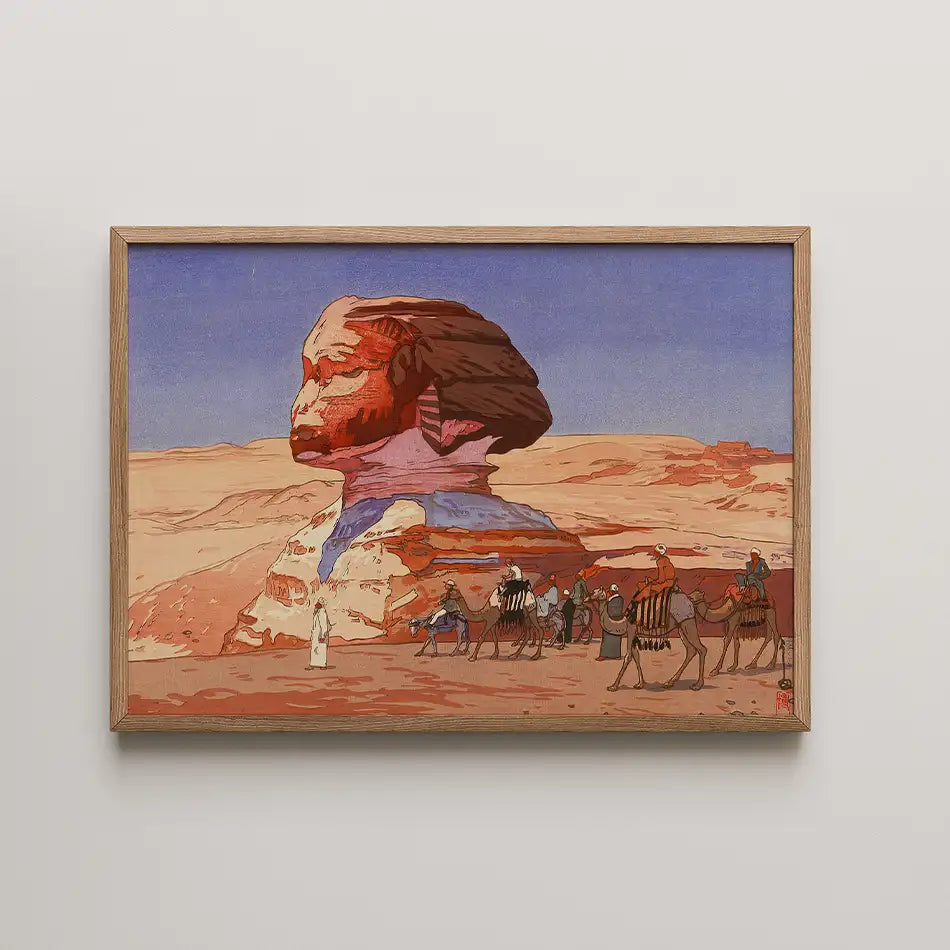 Framed painting of the Sphinx in a desert landscape with camel riders and a blue sky.