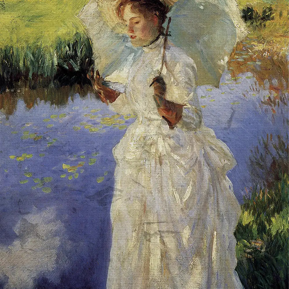 A woman in a white dress holding an umbrella stands by a pond with lily pads, surrounded by lush greenery.