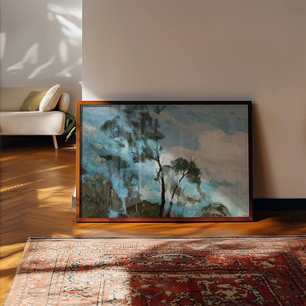 Framed abstract painting of trees against a blue sky, displayed on a wooden floor with a patterned rug and a light-filled room in the background.