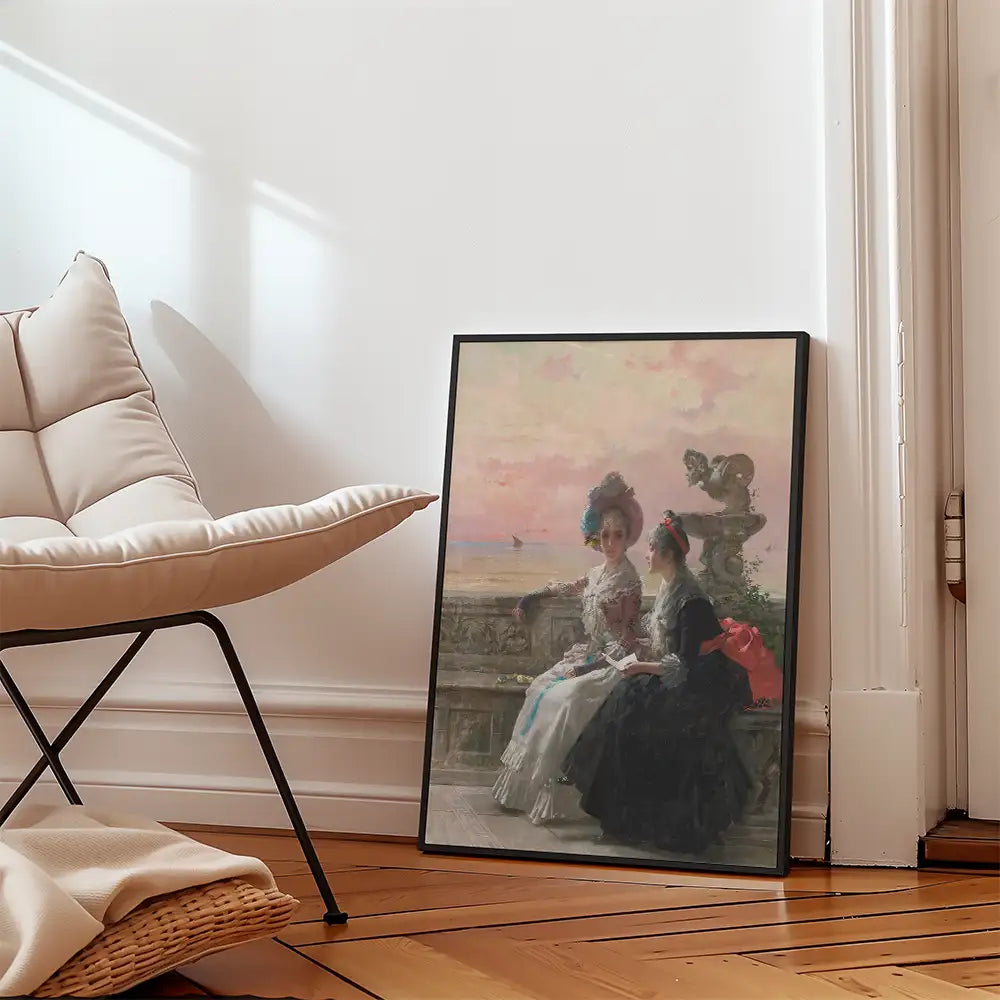 Artistic painting featuring two elegantly dressed women sitting by a decorative balcony with a sunset view, framed and leaning against a wall in a stylish interior setting.