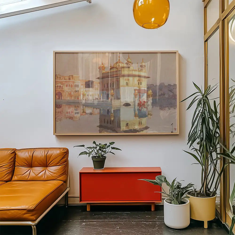 Painting of a serene landscape featuring a reflective body of water framed and displayed above a stylish orange couch in a modern living room setting.