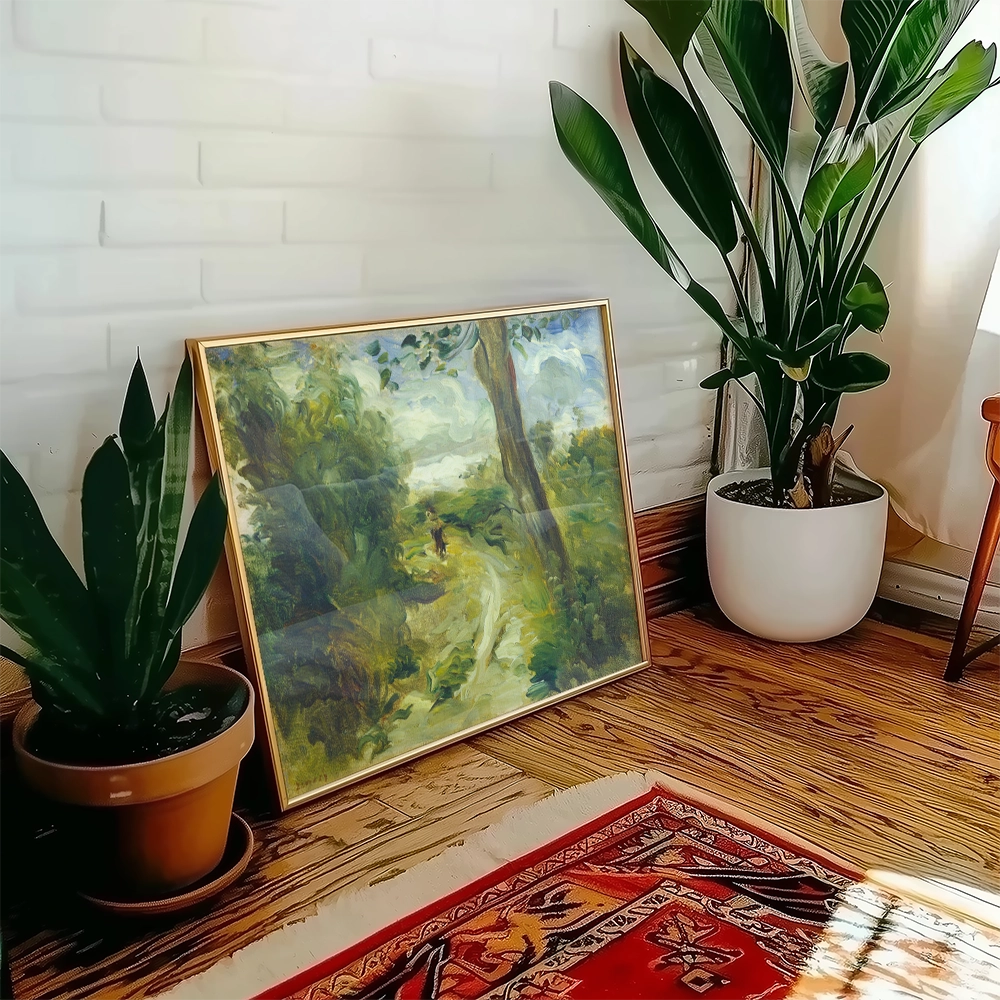 A framed painting of a serene landscape with a winding path, leaning against a wall beside potted plants in a cozy indoor setting.