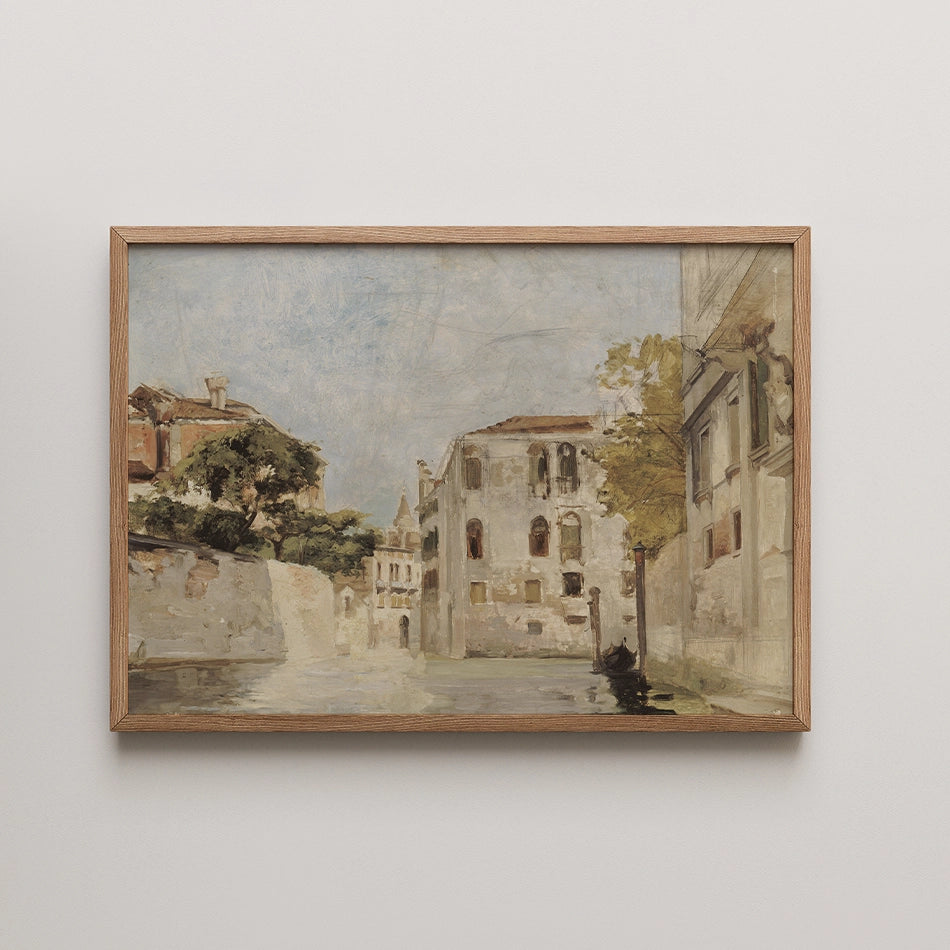 Painting of a serene canal scene with historic buildings and trees, framed in light wood.