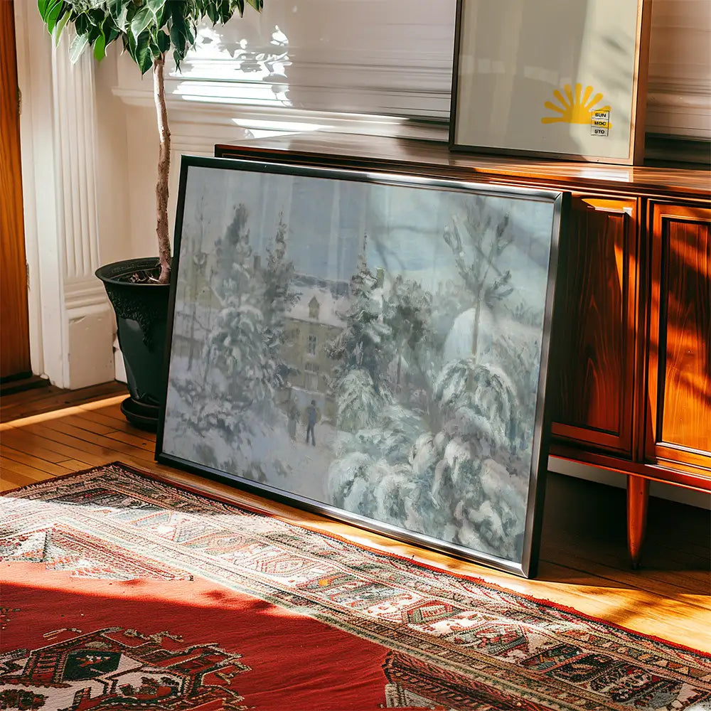 Framed winter landscape painting leaning against a wooden surface, with a decorative rug and a potted plant in the scene.