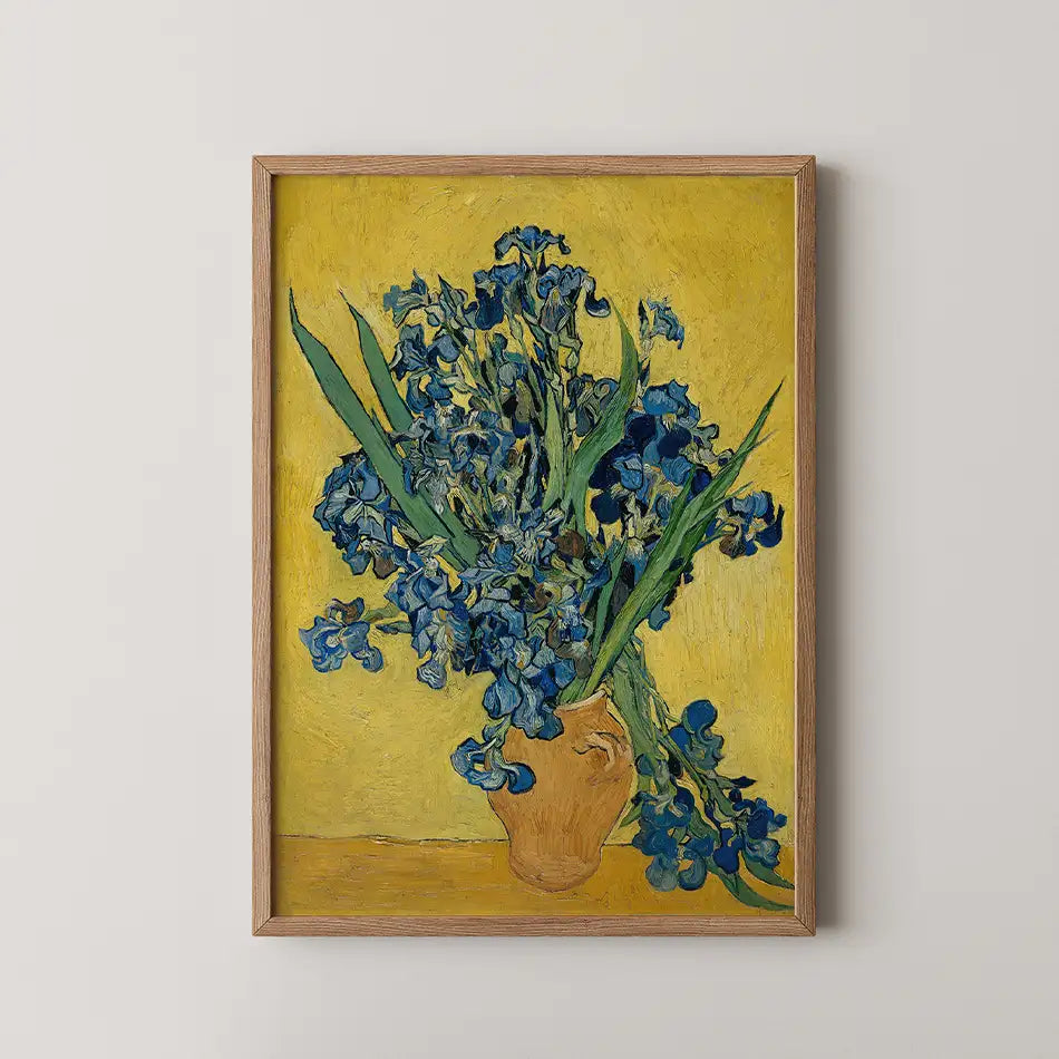 Framed painting of blue flowers in a vase against a yellow background.