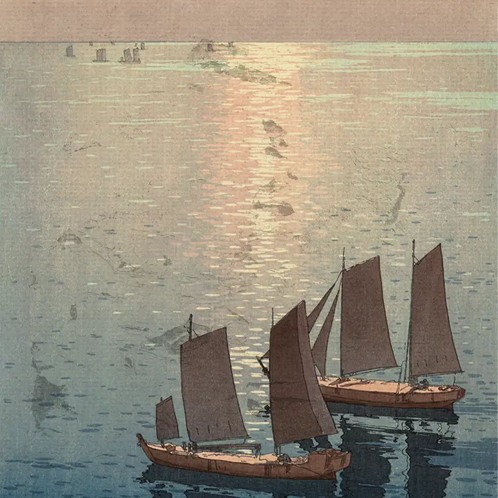 Sailing boats on a calm sea at sunset, with gentle ripples reflecting the warm light.