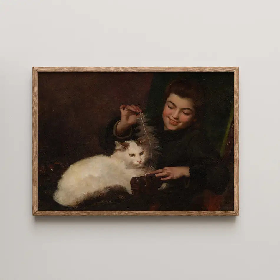 A boy playing with a white cat while holding a feather, depicted in an ornate painting with a wooden frame.