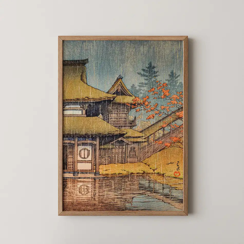 Framed painting of a traditional Japanese house with a thatched roof surrounded by autumn foliage and a tranquil pond, featuring a rain effect.