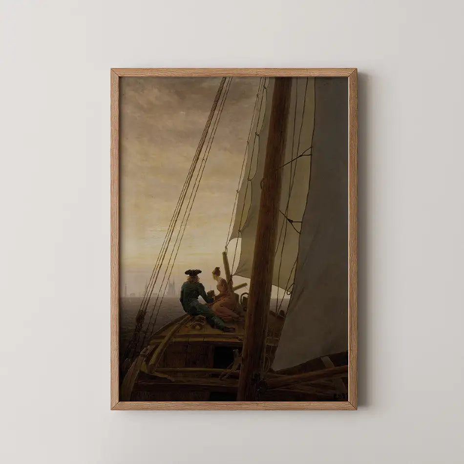 Framed painting of a couple on a sailboat at sunset, featuring detailed sails and calm waters.