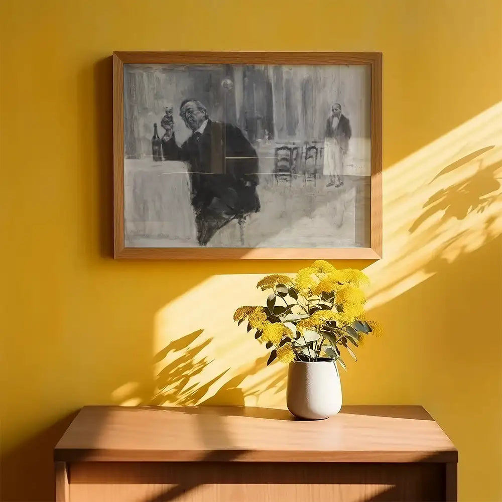 Framed black and white painting of a man enjoying a drink, displayed against a vibrant yellow wall with a vase of yellow flowers on a wooden table.