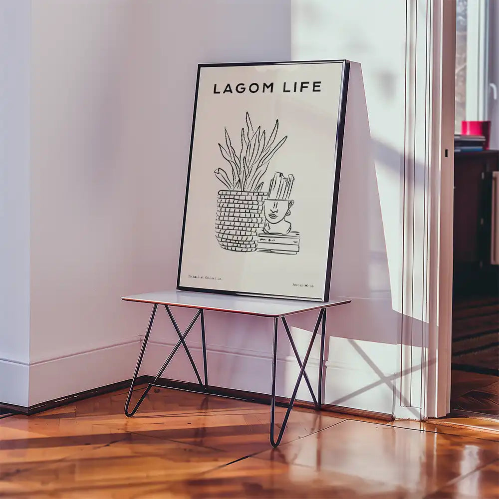 Modern poster featuring "Lagom Life" design with a potted plant and minimalistic artwork displayed on a sleek table in a stylish interior setting.