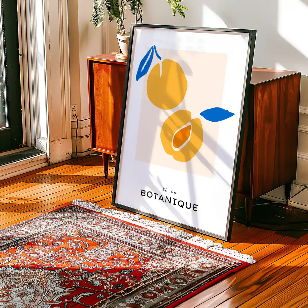 Modern botanical art print featuring abstract yellow fruits and leaves, suitable for home decor, displayed in a contemporary interior setting.