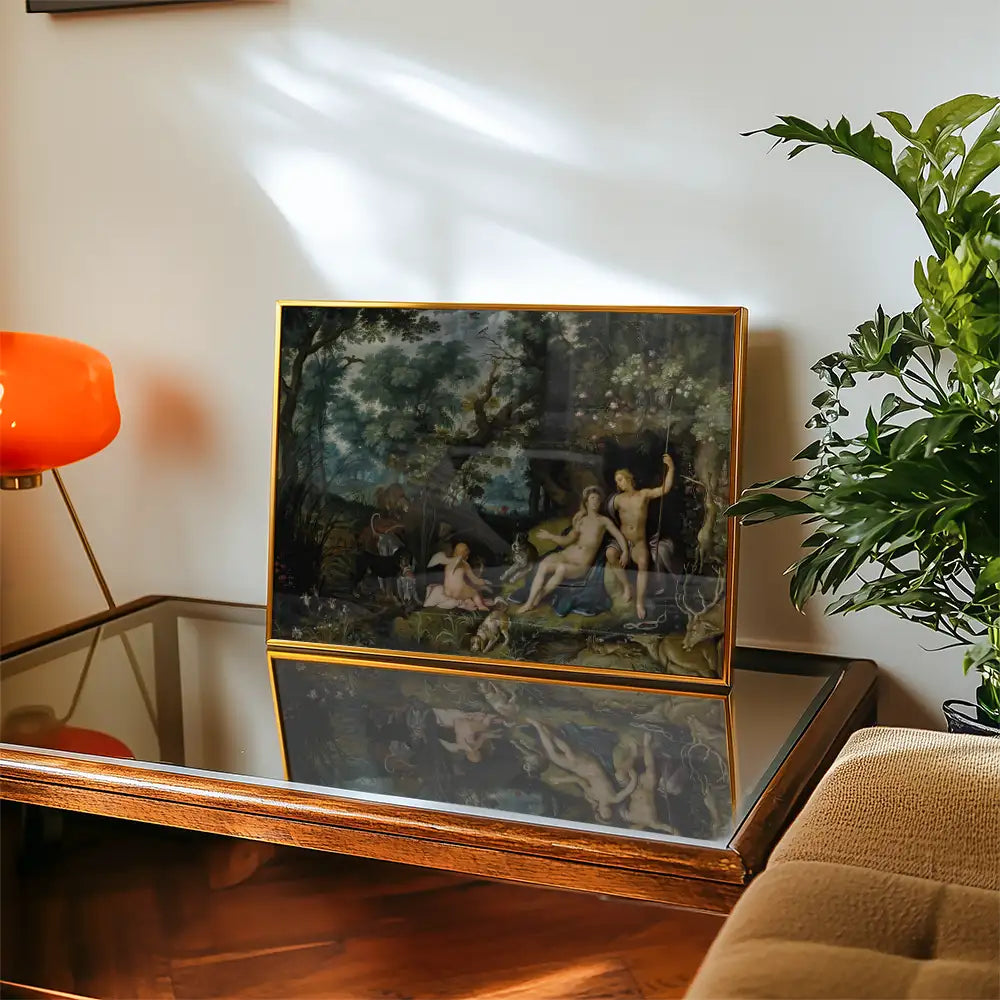 Framed painting displayed on a wooden coffee table with an orange lamp and potted plant in a living room setting.
