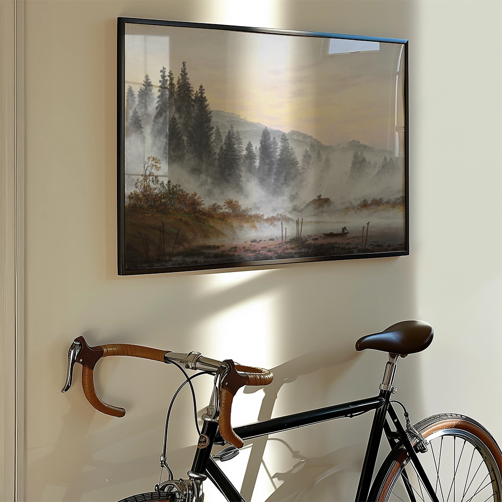 Framed painting of a misty landscape with trees and a body of water, displayed on a wall next to a vintage bicycle.