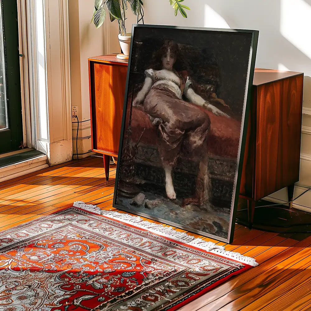 Painting of a seated woman resting on a couch, framed and displayed in a bright room with wooden flooring and a decorative area rug.