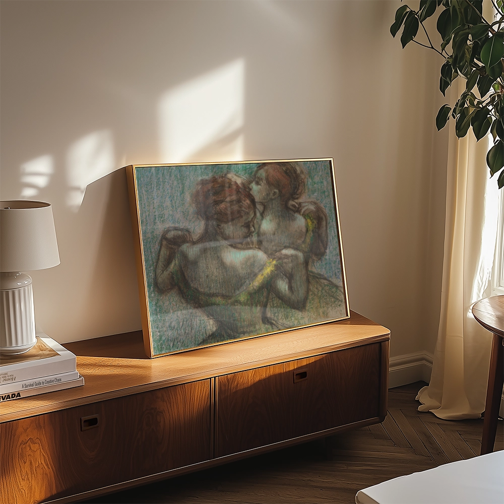 Painting of two figures embracing, displayed on a wooden console table with a lamp and soft natural light filtering through a window.