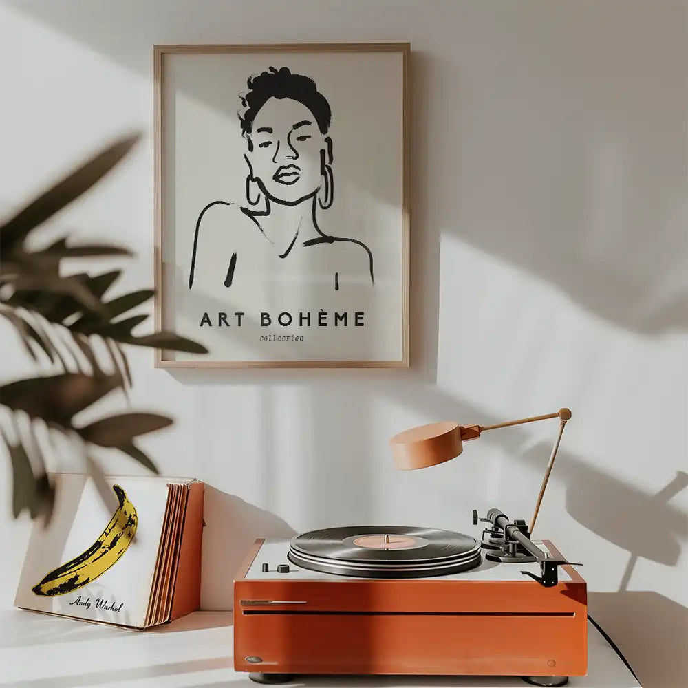 Modern reprint of a famous painting featuring a minimalist line drawing of a woman, displayed in a stylish frame with the text "ART BOHÈME" above, set in a contemporary room with a record player.