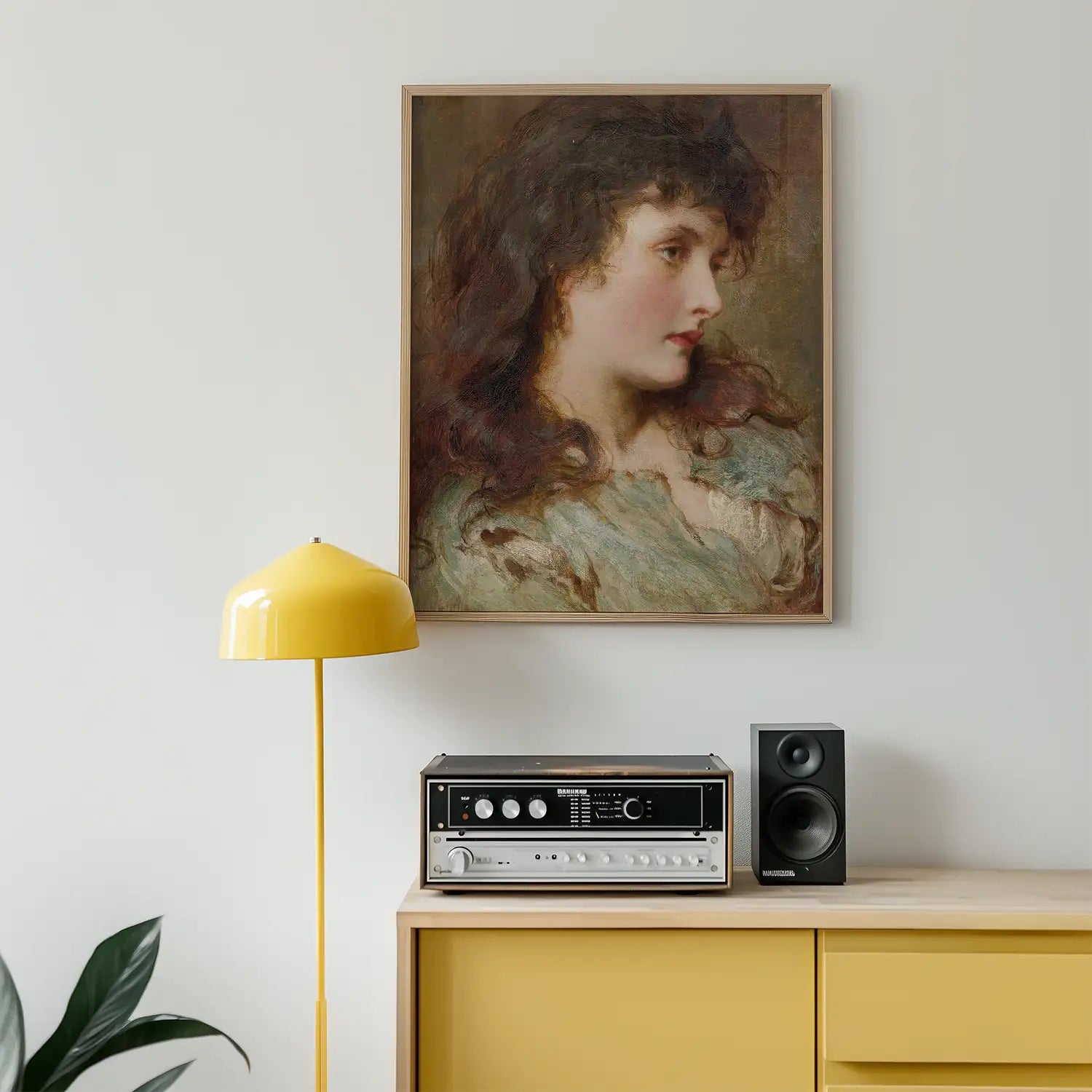 Portrait painting of a woman with long curly hair, displayed in a wooden frame above a yellow lamp and audio equipment on a modern wooden cabinet.