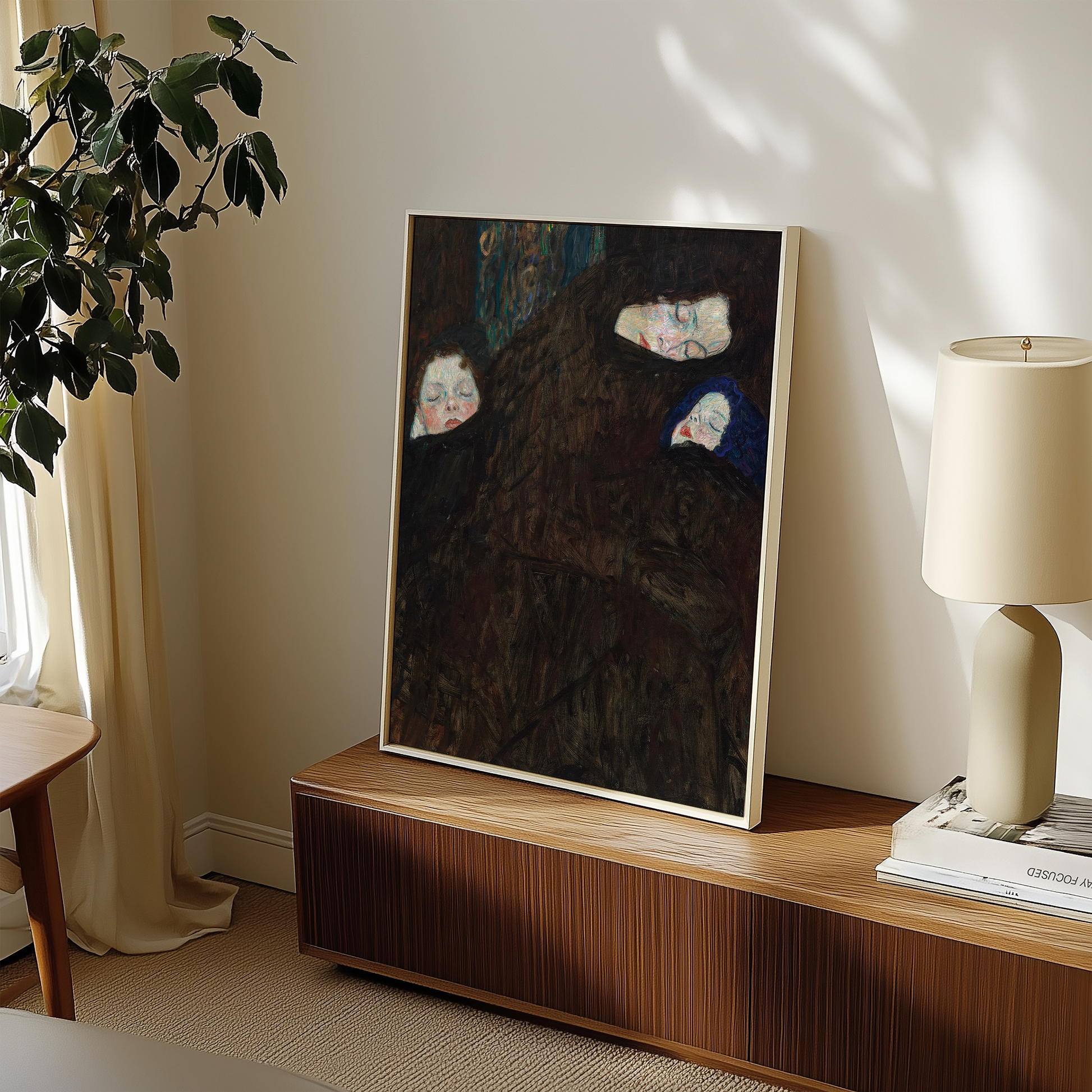 Painting of three figures with abstract features displayed in a modern living space next to a lamp and a plant.