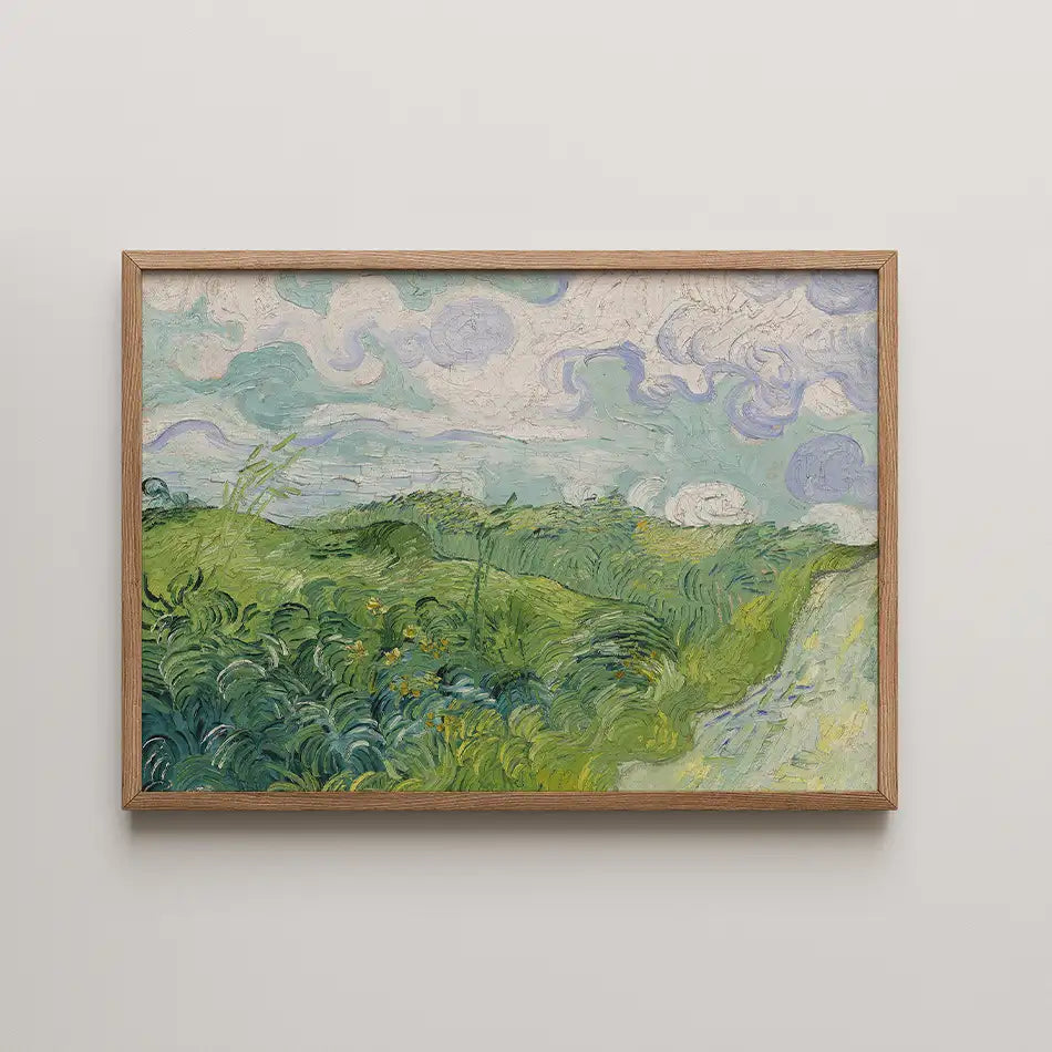Framed painting of a vibrant green landscape with swirling clouds in the sky.