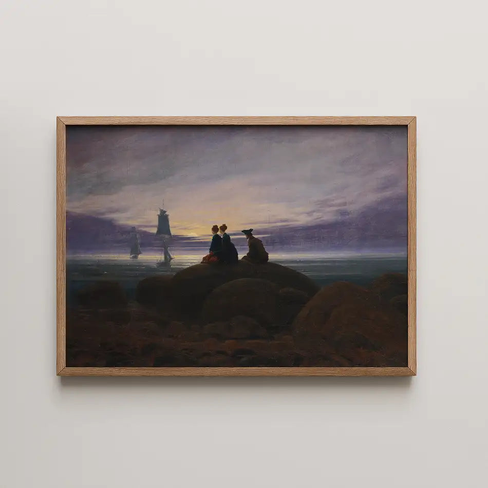 Silhouetted figures on rocks at sunset with sailing ships in the background, framed painting.