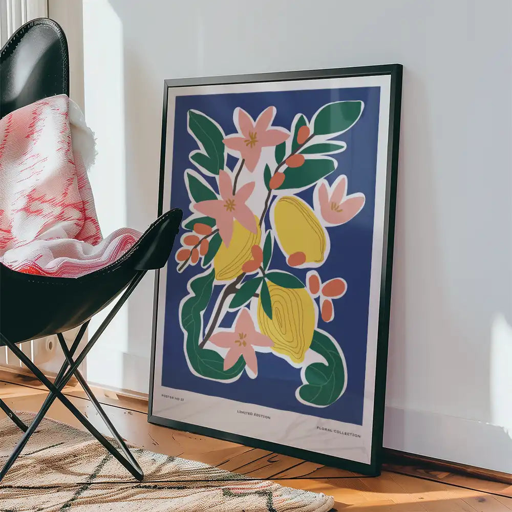 Modern floral art print featuring vibrant colors and abstract shapes, displayed beside a chair and cozy blanket in a contemporary interior setting.