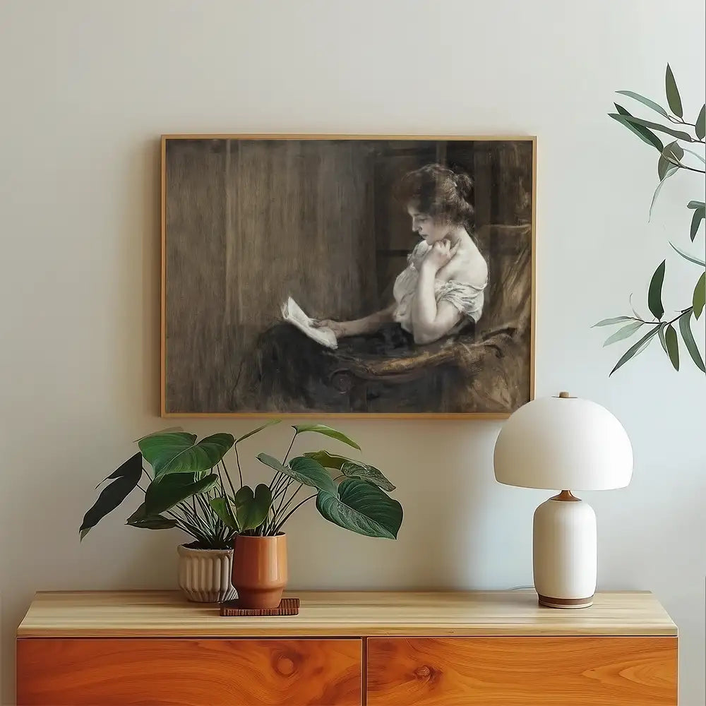 Painting of a woman reading, framed and displayed on a wall above a wooden console table with plants and a lamp.
