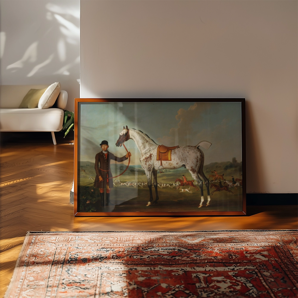 Framed painting of a gentleman with a horse in a pastoral scene, positioned on the floor next to a plush couch in a sunlit room.