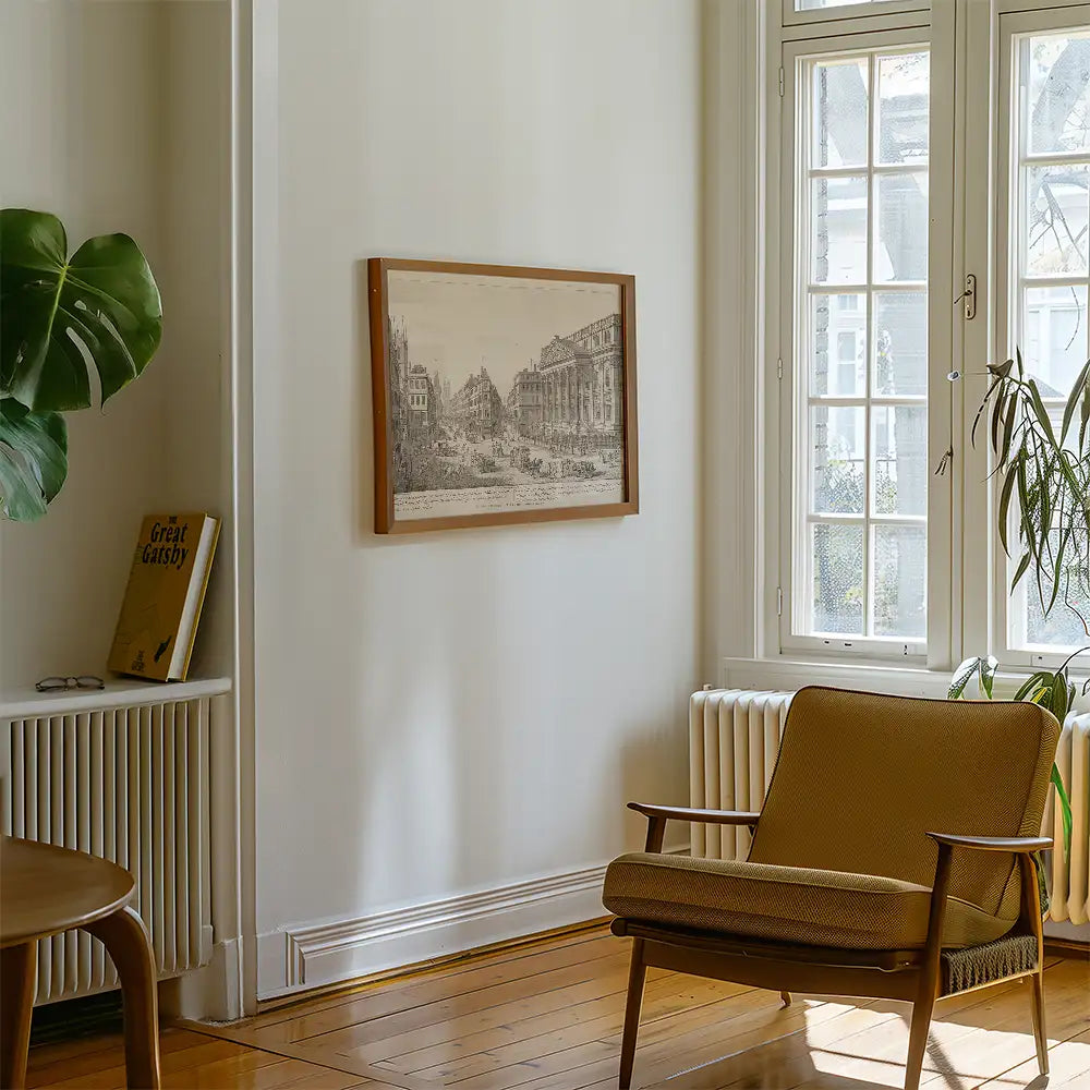 Framed black and white landscape painting on a wall in a cozy room with a wooden chair and indoor plants.