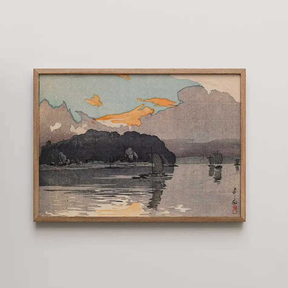 Landscape painting featuring boats on a serene body of water at sunset, framed in wood.