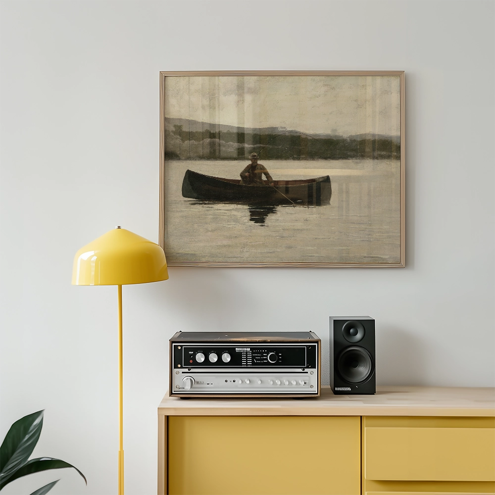 A serene painting of a person in a boat on calm water, framed and displayed above a yellow lamp and a vintage audio system on a wooden sideboard.