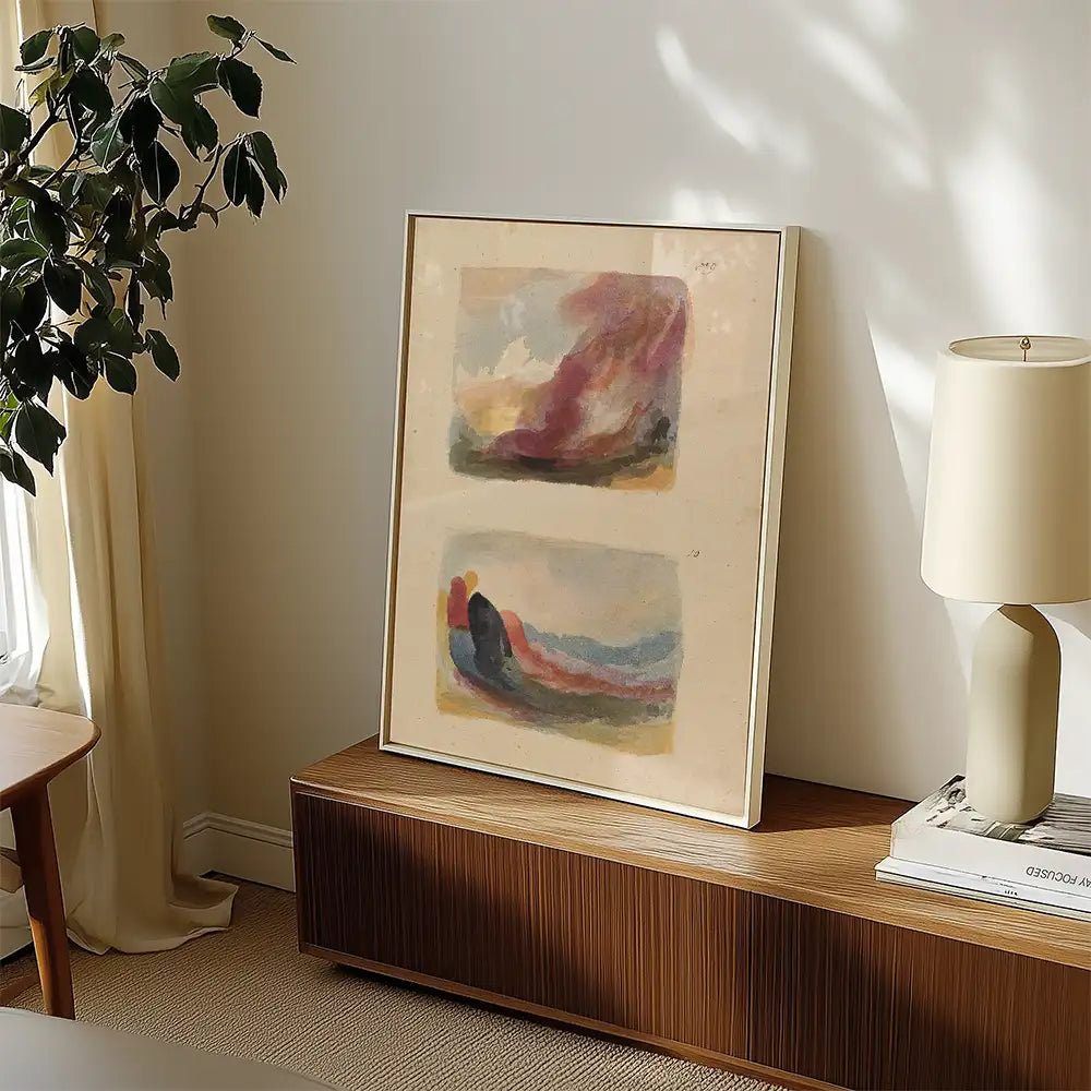 Framed abstract painting featuring soft colors displayed on a wooden console table in a modern living space with a lamp and greenery.