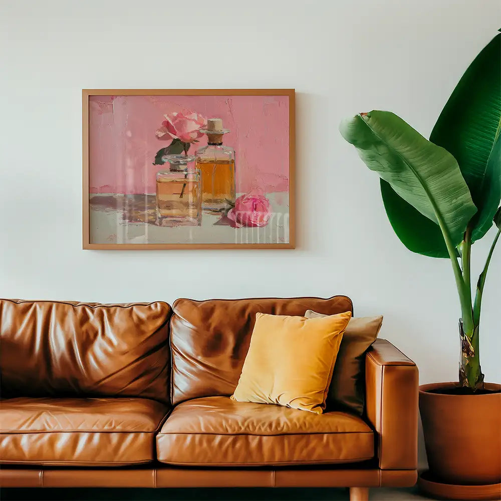 Modern art print of perfume bottles and pink roses, framed and displayed in a stylish living room setting.