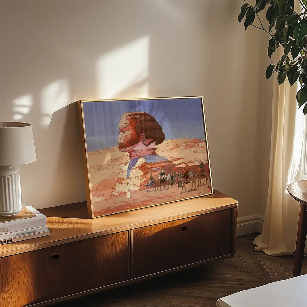 Framed artwork featuring a surreal landscape with a figure’s silhouette and camel caravan, displayed on a wooden console table in a modern living room setting.