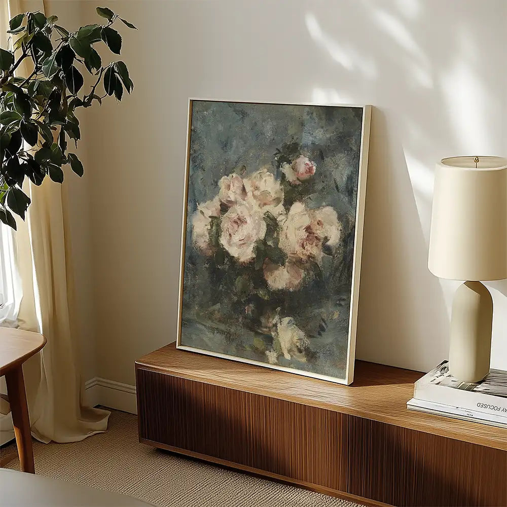 Painting of a floral arrangement featuring soft pink roses, displayed in a modern interior setting with natural light and a wooden console.
