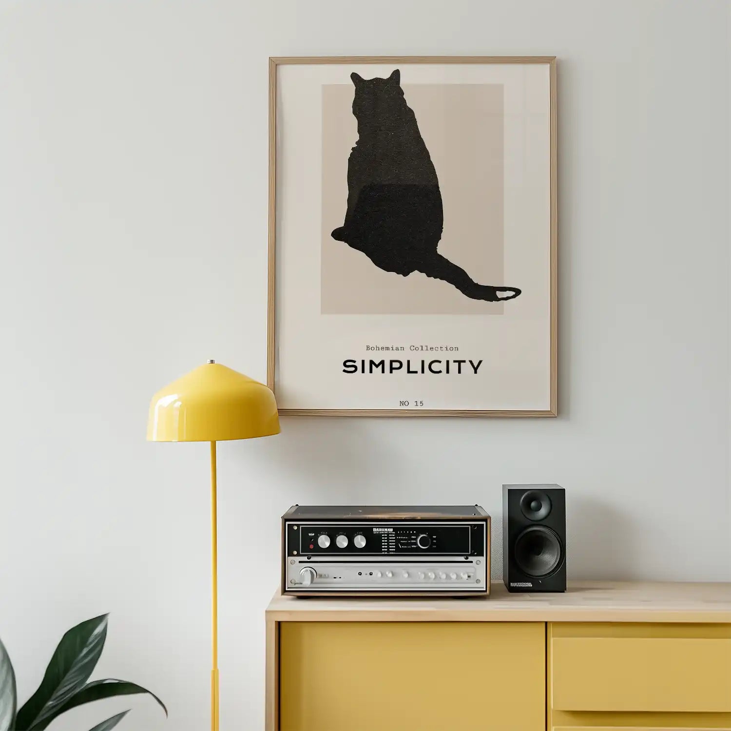 Modern art poster featuring a black cat silhouette with the text "Simplicity" from the Bohemian Collection, framed and displayed in a stylish interior setting.