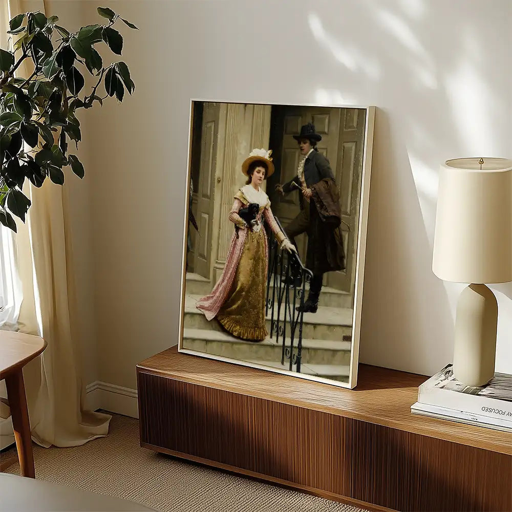 Framed vintage painting of a couple in historical attire standing on steps, displayed in a modern living room setting.