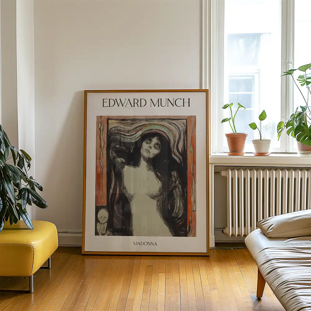 Framed poster of Edward Munch's painting "Madonna" displayed in a modern living space with plants and furniture.