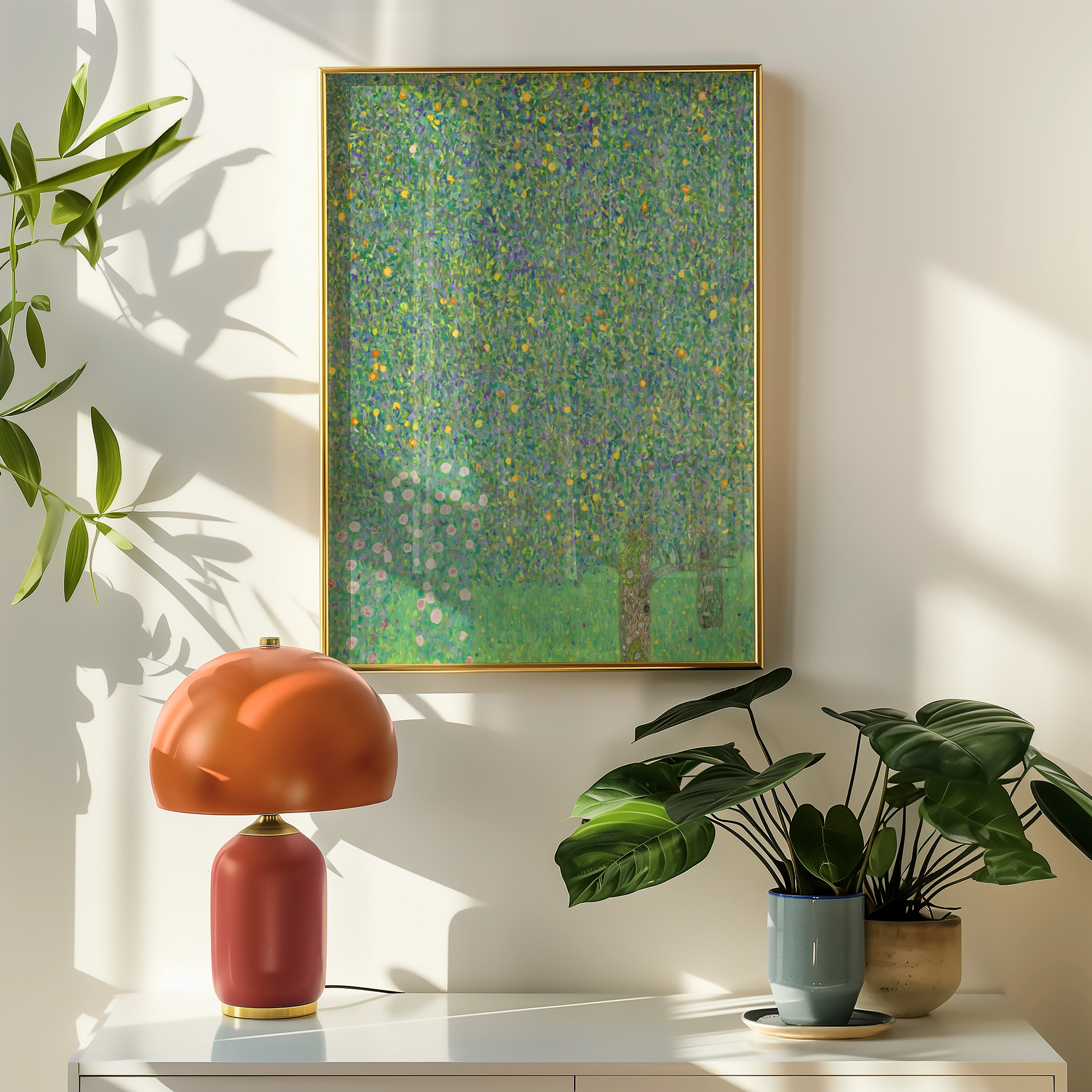 A vibrant abstract painting featuring shades of green, adorned with colorful dots and floral elements, framed in gold, displayed on a wall beside a modern lamp and potted plants.