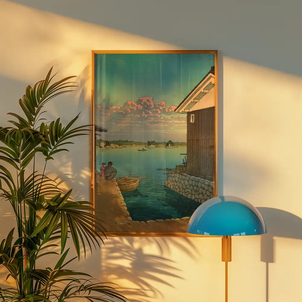 Framed landscape painting depicting two figures by a river with a boat and a house, surrounded by water and trees, illuminated by warm sunlight.