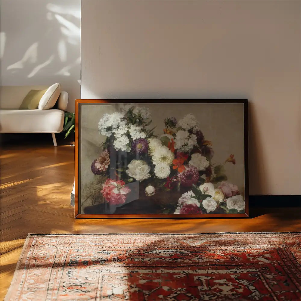 Framed painting of a vibrant floral bouquet displayed on a wooden floor next to a rug and a modern couch in a well-lit room.