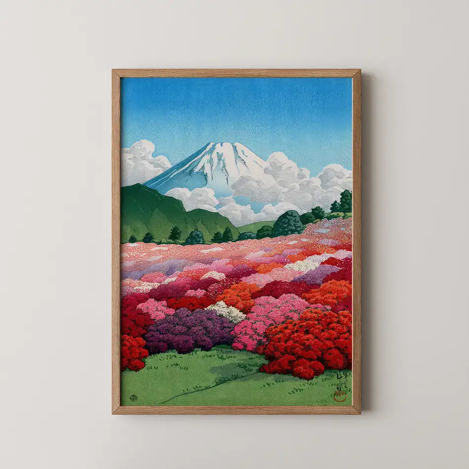 Framed painting of a vibrant flower field in the foreground with Mount Fuji in the background under a bright blue sky with clouds.