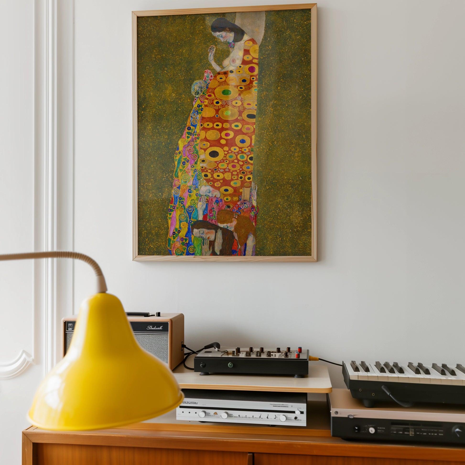 Painting of a woman in a colorful dress, hanging on a wall above a vintage audio setup and a yellow lamp.