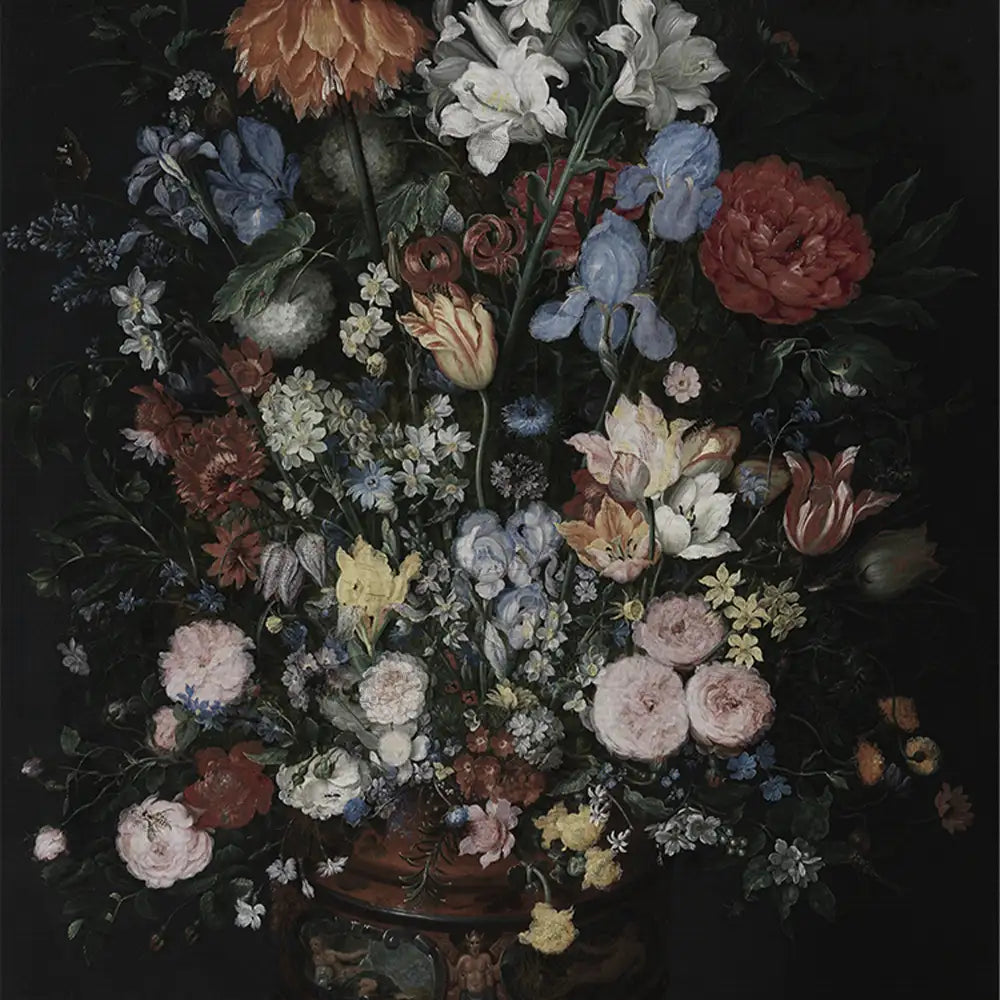 A vibrant arrangement of various flowers in a decorative vase on a dark background.