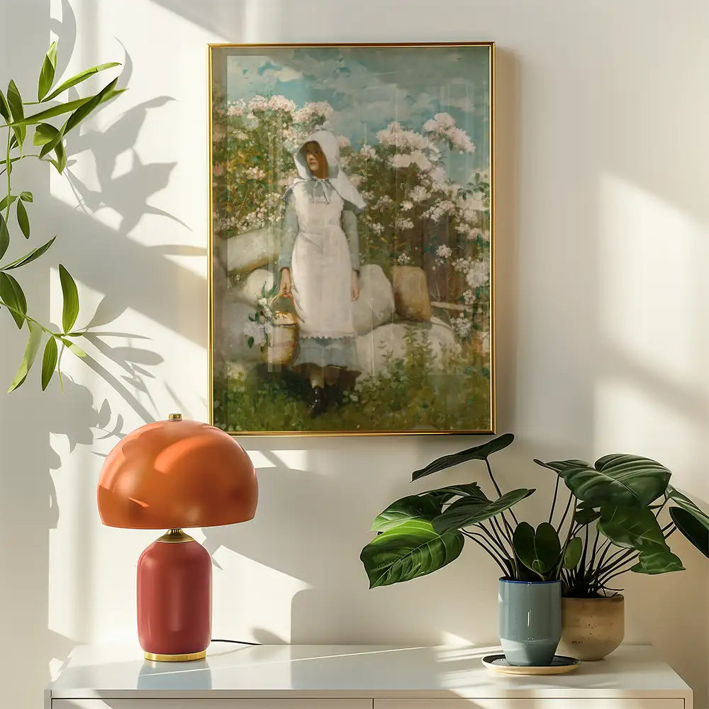 A vintage painting of a woman in a white dress holding a basket, surrounded by flowers, hanging on a wall next to a contemporary lamp and potted plants.
