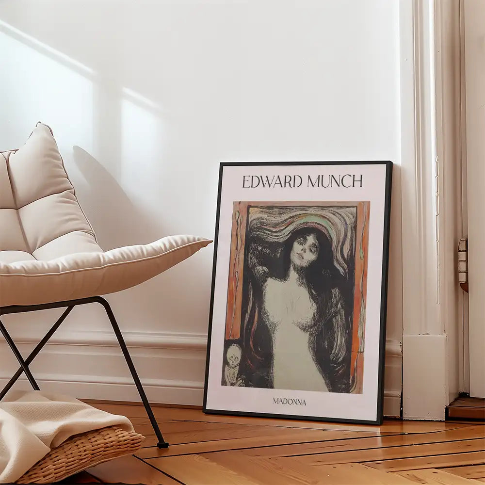 Edward Munch's "Madonna" poster leaning against a wall beside a modern chair.