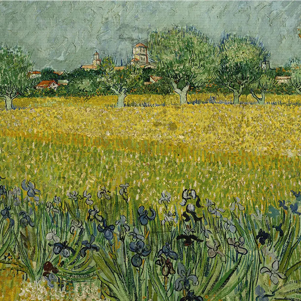 Vincent van Gogh painting depicting a vibrant yellow field with blooming iris flowers in the foreground and a distant village with trees and buildings in the background.